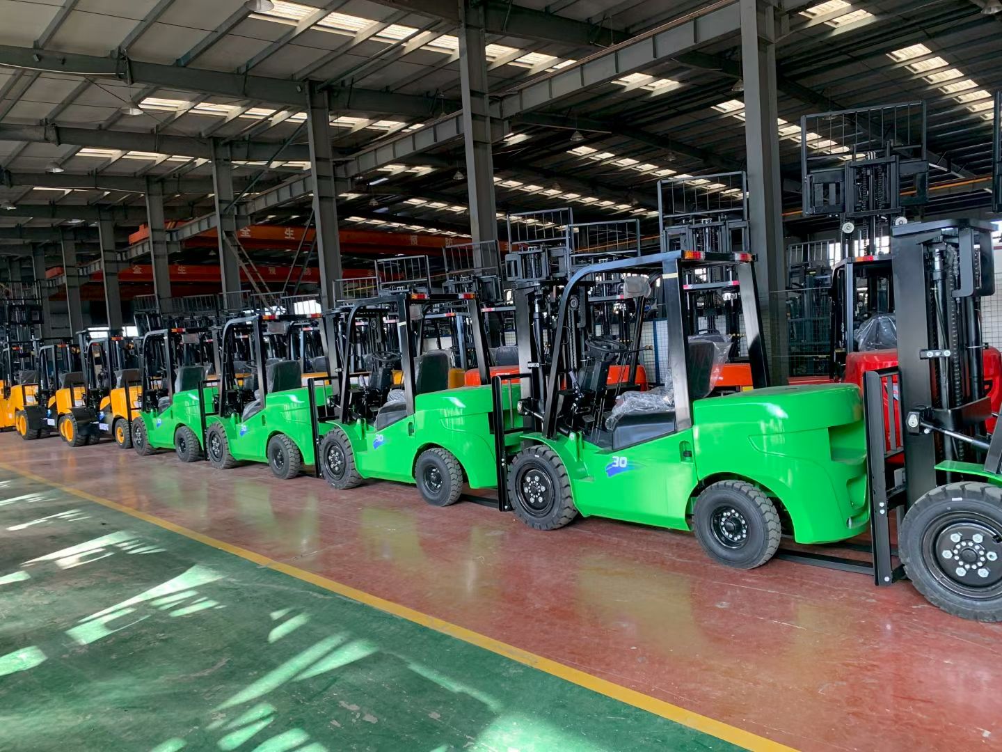 Row of finished 2-3 ton forklifts lined up for final inspection