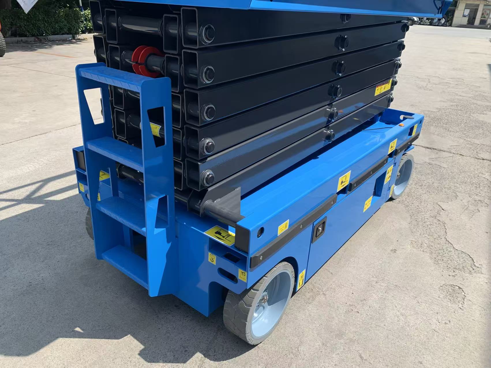 Blue scissor lift, side view